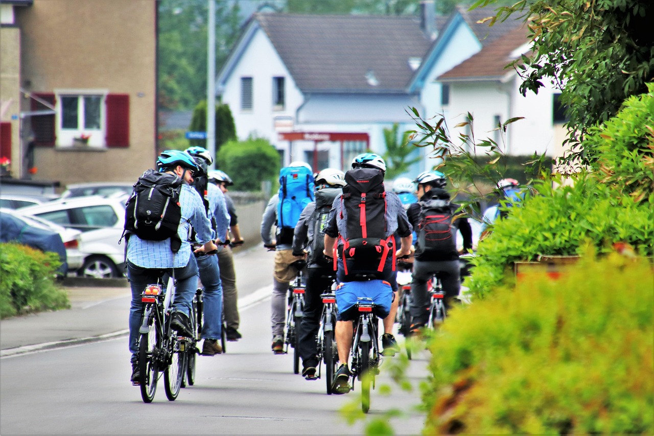 Male cyclist with backpack on city street
